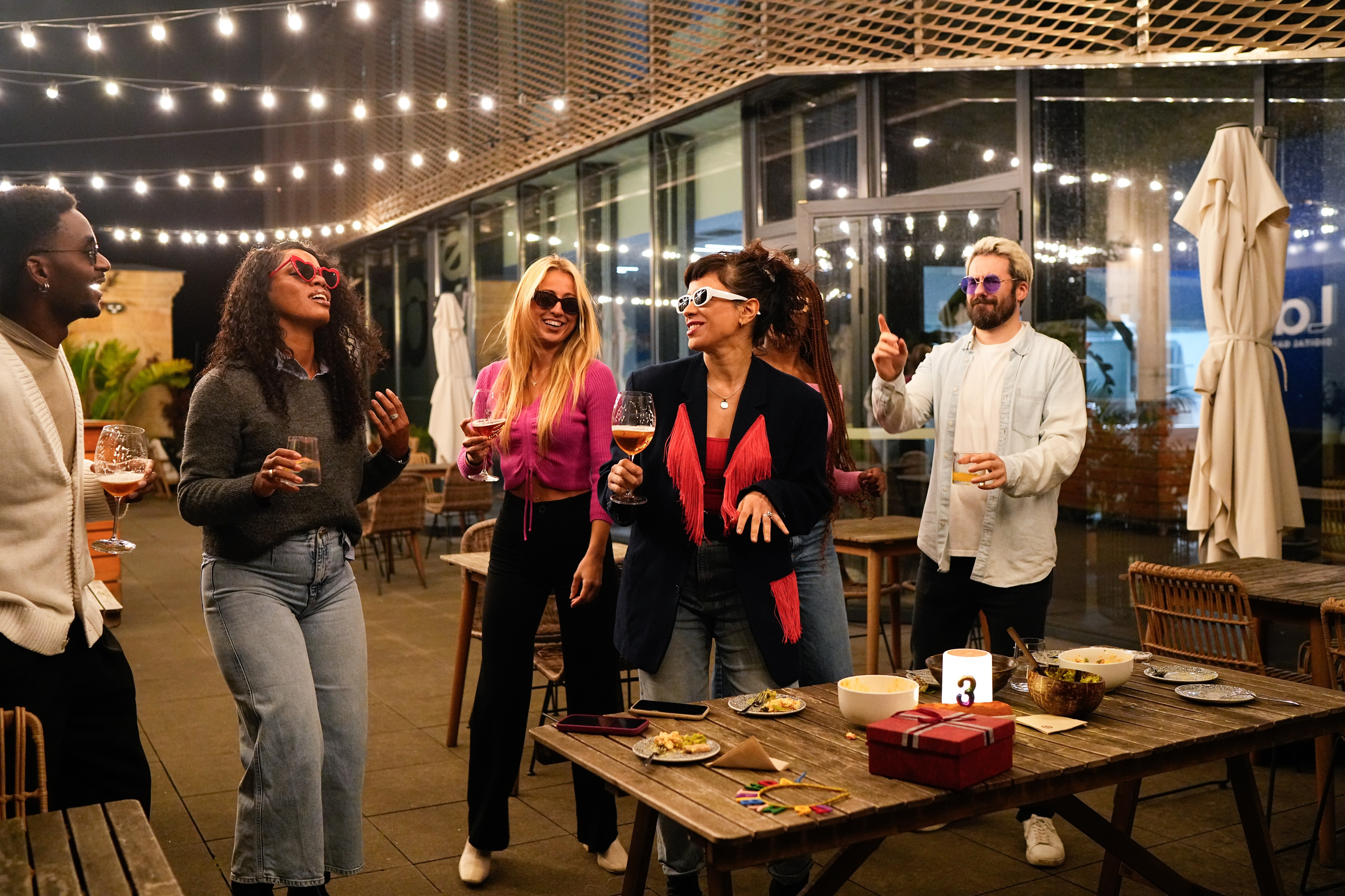 Friends enjoying drinks and dancing